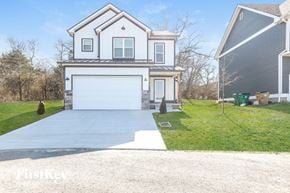 Madison house for rent - a white house with a driveway and a white garage door