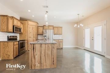 Madison house for rent - a large kitchen with wooden cabinets and stainless steel appliances