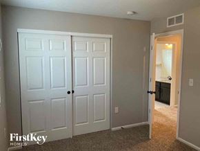 Commerce City house for rent - a bedroom with two closets and a door to a bathroom
