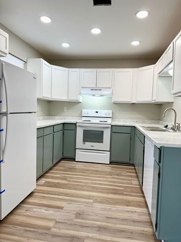 Lafayette apartment for rent - a kitchen with green and white cabinets and white appliances