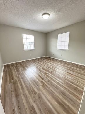 Lafayette apartment for rent - an empty living room with wood flooring and two windows