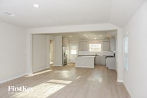 San Antonio house for rent - A spacious kitchen and living room with white walls and wooden floors.