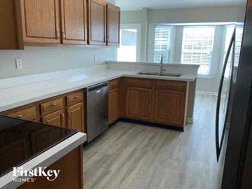 Middleburg house for rent - a kitchen with wooden cabinets and stainless steel appliances