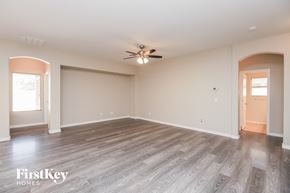 San Tan Valley house for rent - the living room of an empty house with a ceiling fan