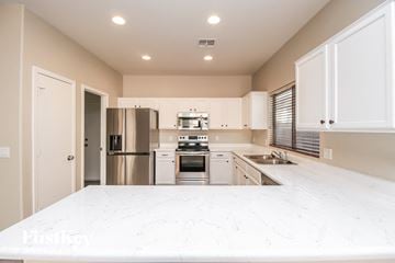 San Tan Valley house for rent - a white kitchen with stainless steel appliances and white counter tops