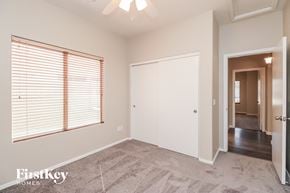 San Tan Valley house for rent - a bedroom with a large window and a door to a hallway