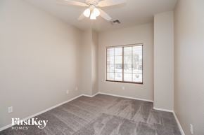 San Tan Valley house for rent - the spacious living room with a ceiling fan and a window