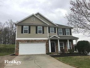 Gastonia house for rent - a brown house with a white garage door