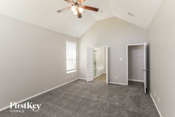 Rowlett house for rent - a living room with carpet and a ceiling fan