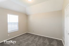 Rowlett house for rent - a bedroom with a carpeted floor and a window
