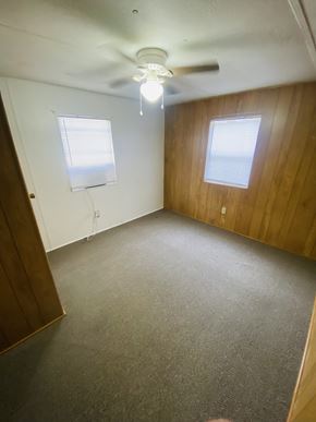 Egan apartment for rent - an empty room with a ceiling fan and two windows