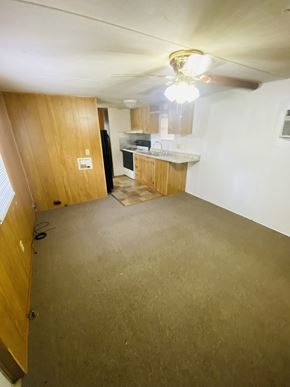 Egan apartment for rent - an empty living room with a kitchen in the background