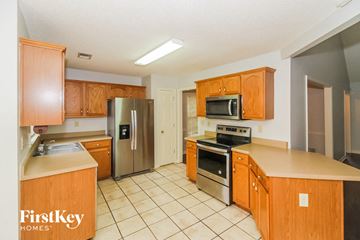 Memphis house for rent - a kitchen with wooden cabinets and stainless steel appliances