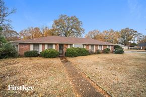 Memphis house for rent - a brick house with a yard in front of it