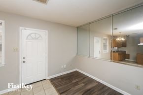Memphis house for rent - a living room with a white door and a large mirror