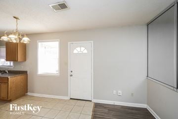 Memphis house for rent - a kitchen with a white door and a refrigerator and a sink