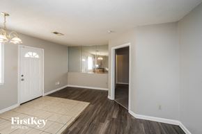 Memphis house for rent - an empty living room with a door to the bathroom and a hallway to the kitchen