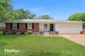 Bartlett house for rent - A house with a white garage door and a brick facade.