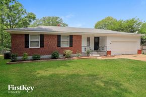 Bartlett house for rent - A brick house with a white garage door and a black door.