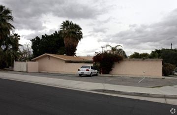 Palm Desert apartment for rent - a car parked in front of a house with palm trees