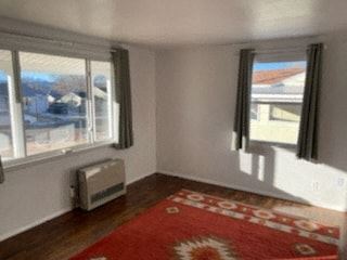 Trinidad house for rent - a living room with a red rug and three windows