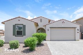 Surprise house for rent - A white house with a garage door and a window with green shutters.