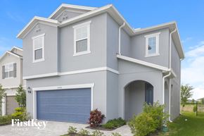 Wesley Chapel house for rent - A modern house with a garage door is for sale.