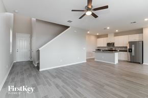 Wesley Chapel house for rent - A spacious kitchen and living room with a staircase leading to the upper floor.