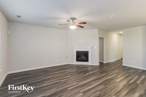 Fort Worth house for rent - a living room with a fireplace and a ceiling fan