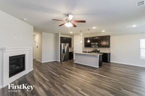 Fort Worth house for rent - a kitchen and living room with wood flooring and a fireplace
