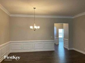 Mooresville house for rent - A well-lit room with a chandelier and wooden floors.