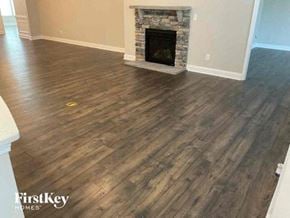 Mooresville house for rent - A room with a fireplace and wooden flooring.