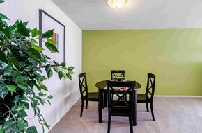 Pontiac apartment for rent - a dining room with a table and chairs and a green wall