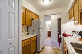 Pontiac apartment for rent - a kitchen with a refrigerator and a sink      and a door