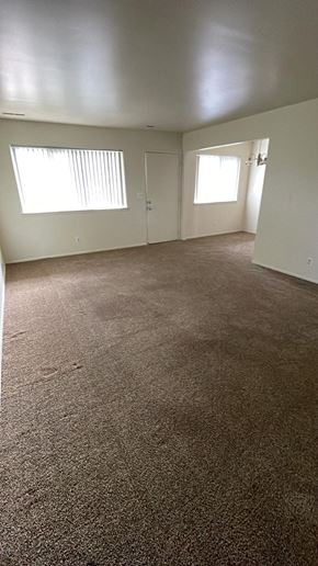 Davison apartment for rent - an empty living room with a carpeted floor