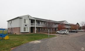 Davison apartment for rent - a building with a white van parked in front of it