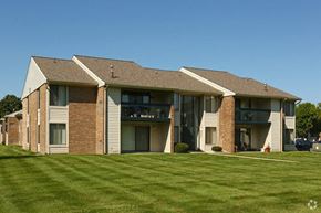 Saginaw apartment for rent - a large apartment building with a green lawn