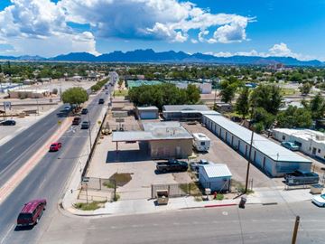 Las Cruces apartment for rent - A city street with a red bus and cars on a sunny day.