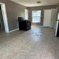 Killeen apartment for rent - an empty living room with a refrigerator and