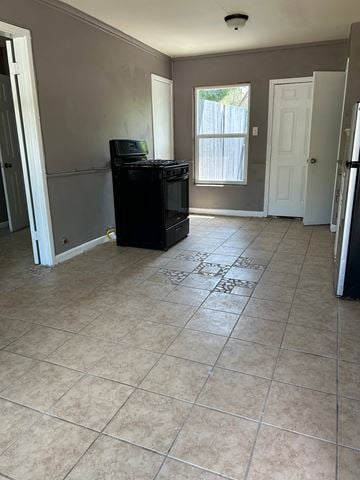 Killeen apartment for rent - an empty kitchen with a tile floor and a stove