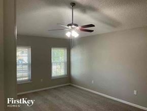 Jacksonville house for rent - a bedroom with a ceiling fan and a window
