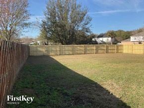Jacksonville house for rent - a fenced in backyard with a fence and grass