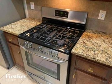 Monroe house for rent - a stainless steel stove top oven in a kitchen