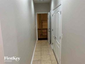 Monroe house for rent - a hallway with a door to a kitchen and a staircase