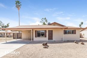 Glendale house for rent - a white house with a yard and a palm tree