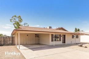 Glendale house for rent - a white house with a driveway and a garage door