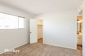 Glendale house for rent - a bedroom with a large window and a door to a bathroom
