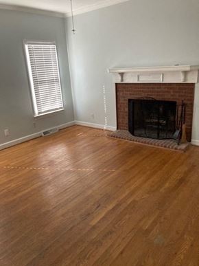Rome apartment for rent - a living room with a fireplace and a wooden floor