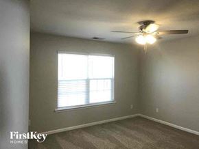 Belmont house for rent - a bedroom with a ceiling fan and a window