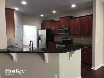 Belmont house for rent - a kitchen with a black counter top